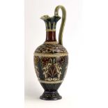 A late 19th century Doulton Lambeth ewer with incised foliate decoration within jeweled borders on