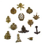 A group of thirteen cap badges relating to support and auxiliary regiments including Royal