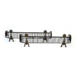 A pair of steel rope-twist fire curbs with brass Arts & Crafts stands to the front, l.