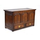 An 18th century oak mule chest, the lift lid over three panels and two drawers,