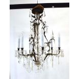 An early 20th century brass and Bavarian crystal three-branch chandelier of foliate design,