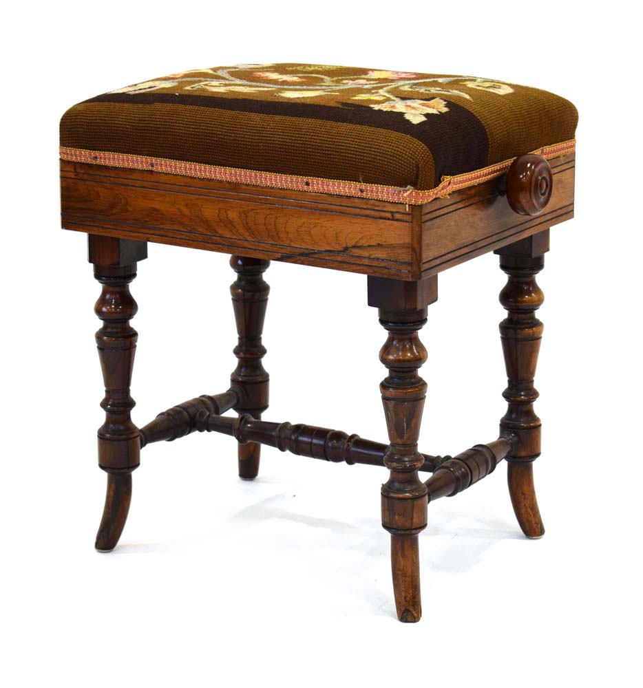 A late 19th century rosewood and embroidered adjustable stool with turned supports and a cross