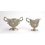 A Victorian silver two handled sugar bowl repousse decorated in the Rococo manner,