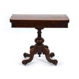 A 19th century mahogany games table, the folding surface on a turned column and four splayed legs,
