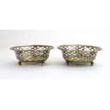 A pair of early 20th century pierced silver bon bon dishes of circular form with tied borders on