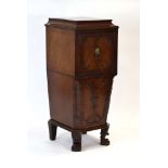 A late 19th century mahogany cabinet of tapering form, the top door with a brass lion's mask handle,