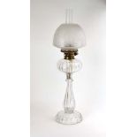 A cut glass oil lamp with an etched glass floral shade, h.