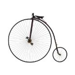 A Victorian Ordinary or Penny Farthing with a black and red highlighted frame,