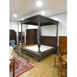 A 19th century carved tester bed with acanthus capped supports, a panelled canopy and turned feet,