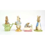 Four Beswick Beatrix Potter figures: Peter Rabbit, Peter Rabbit Gardening,