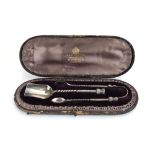 A cased Victorian silver sugar tongs and matching caddy spoon, each decorated with a thistle design,