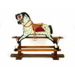 A mottled grey painted rocking horse on a pine twin pillar stand, w.