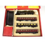 A Trix Twin OO gauge passenger train set comprising 4-4-0 loco,
