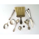 A mixed parcel of silver and metalware comprising a crumb brush, six collector's spoons,