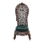 An Anglo-Indian fretwork hall chair intricately carved with fruiting vines,