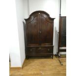 A Dutch oak cupboard, the two panelled doors enclosing gilt fretwork interior,