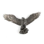 A French white metal articulated brooch in the form of an eagle clutching a serpent