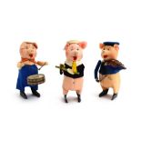 Three Schuco felt and clockwork pigs,