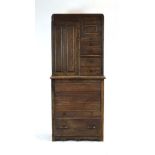 A 1930/40's American oak dentist's cabinet with an arrangement of drawers, doors,
