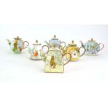 Six Charlotte di Vita Beatrix Potter miniature enamelled teapots and covers, max h.