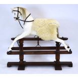 A white painted rocking horse on a stained pine twin pillar stand, w.