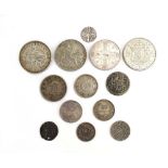 A small group of silver coinage including a 50 sen coin, an Edward I hammered penny, an 1889 crown,