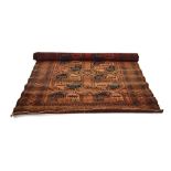 An early 20th century rug, the red ground with red and blue geometric repeated motifs,