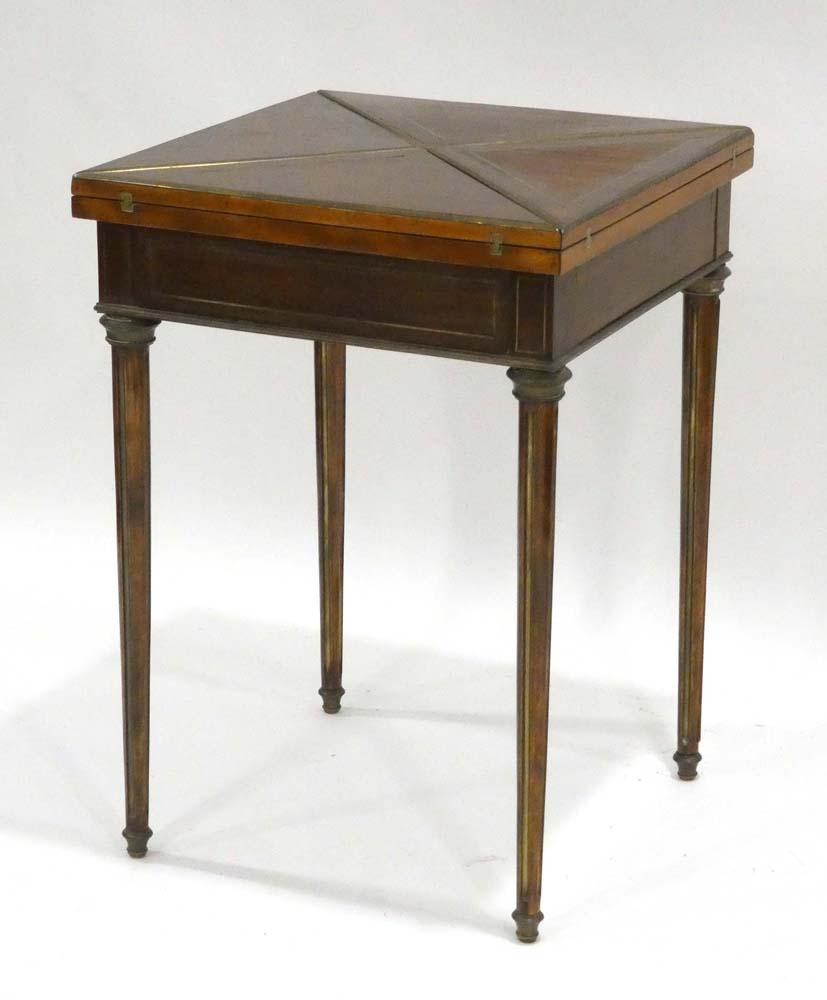 A mahogany and brass mounted envelope games table,