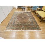 An Indian carpet decorated with blue and red floral motifs,