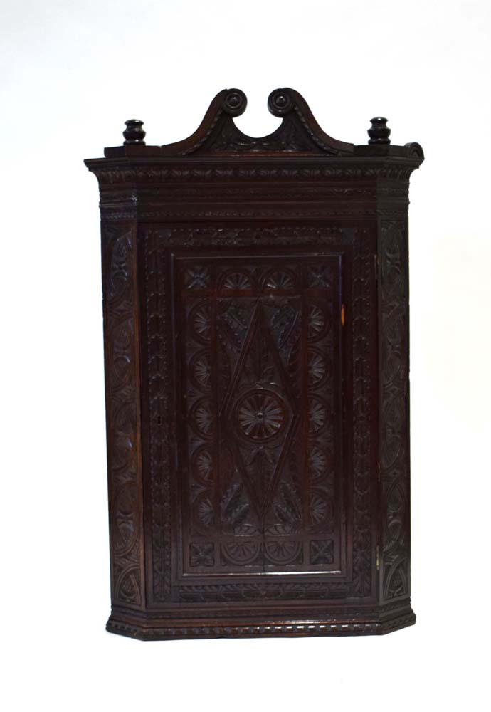 An 18th century corner cabinet with later wheel and geometric carvings below a scrolled pediment, h. - Image 2 of 3