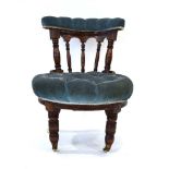 A Victorian mahogany and button upholstered lowback chair on turned front legs