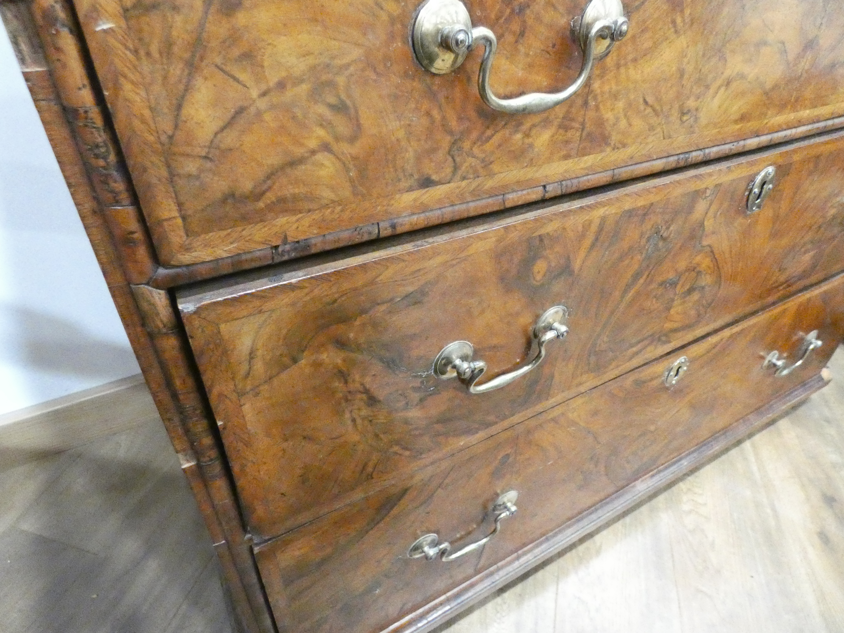 A Georgian walnut and feather crossbanded chest of three short over three long drawers on later bun - Image 6 of 27