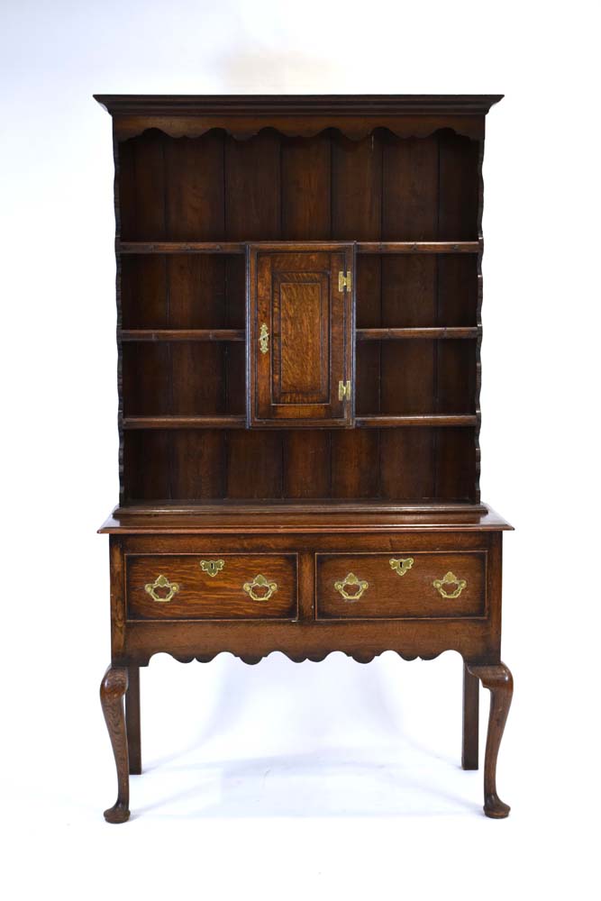 A Georgian-style oak dresser, the four-tier plate rack with a central cupboard,