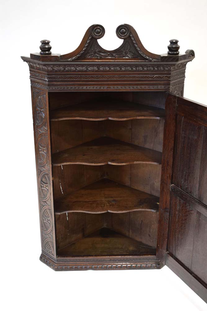 An 18th century corner cabinet with later wheel and geometric carvings below a scrolled pediment, h. - Image 3 of 3