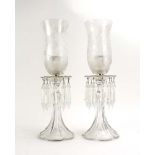A pair of mid-20th century clear glass table lustres, each with an etched glass shade above drops,