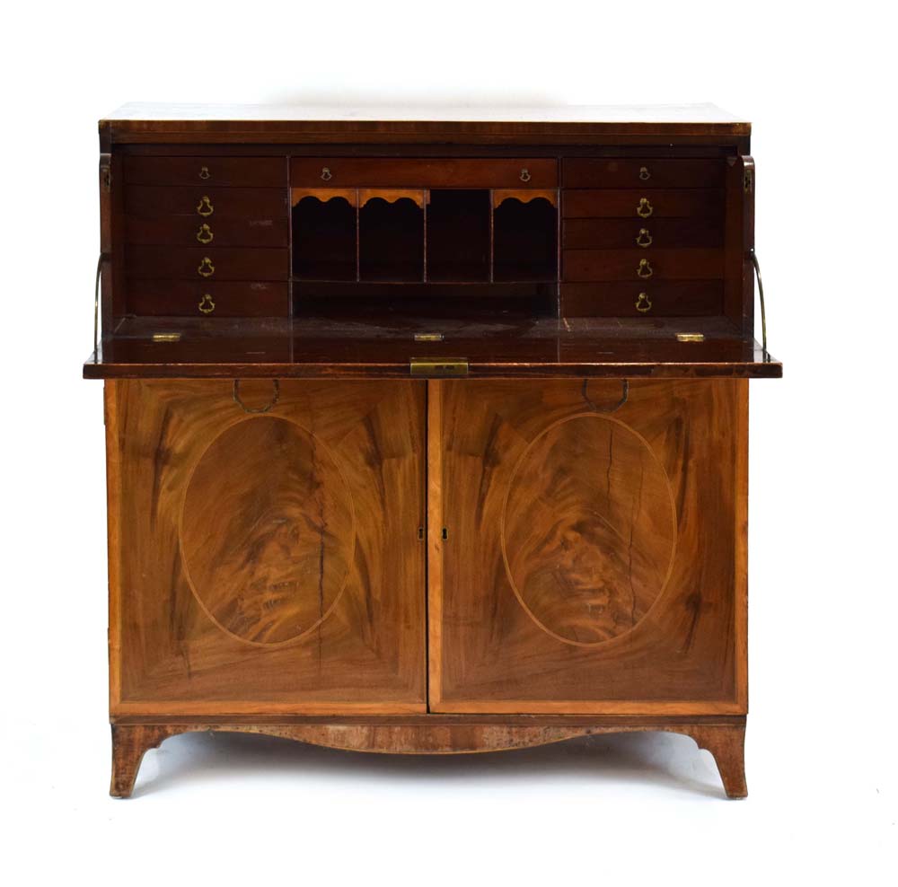 A Georgian mahogany, strung and crossbanded secretaire, the fall-front enclosing a fitted interior,