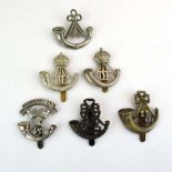 A group of six Light Infantry cap badges including Somerset, Durham etc.