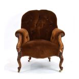 A Victorian mahogany and button upholstered armchair on scrolled legs with castors