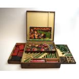 A wooden box containing a quantity of mid-20th century Meccano pieces,