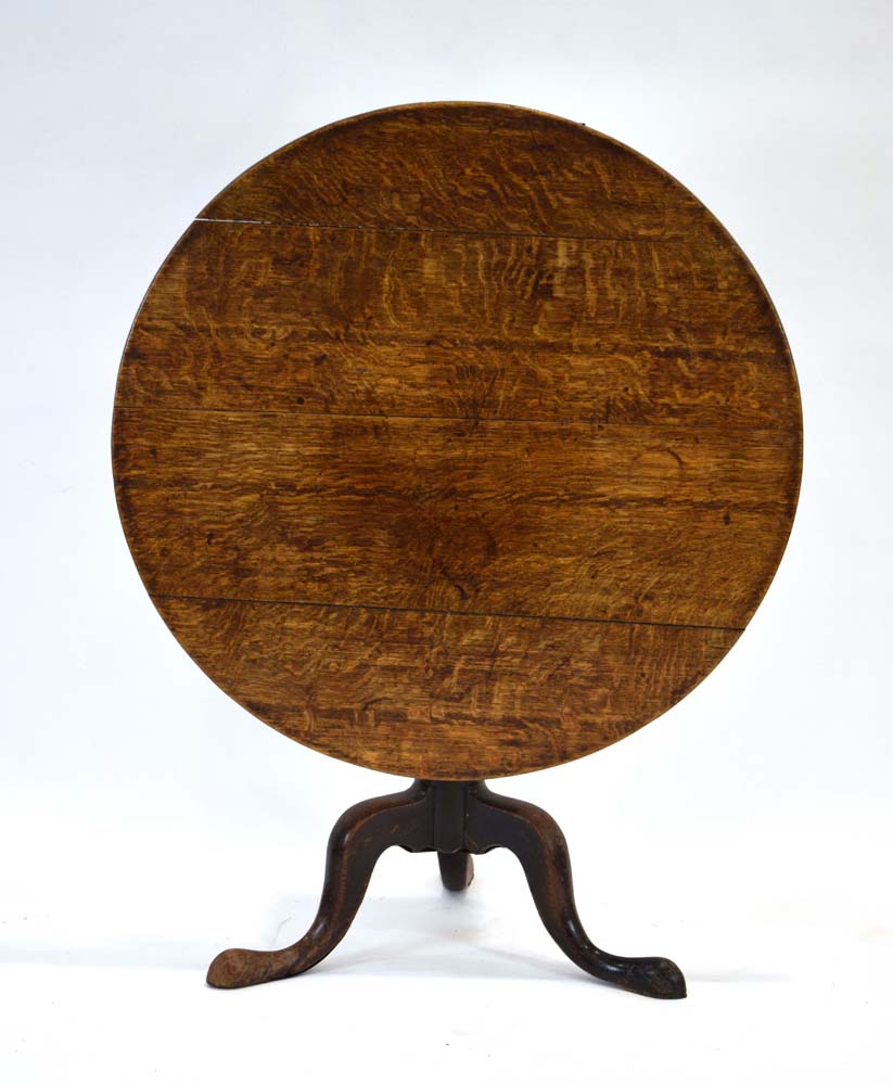 A George II oak tilt-top supper table with a turned column and three splayed legs, d.