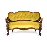 A Victorian mahogany and button uphosltered sofa with foliate carvings,