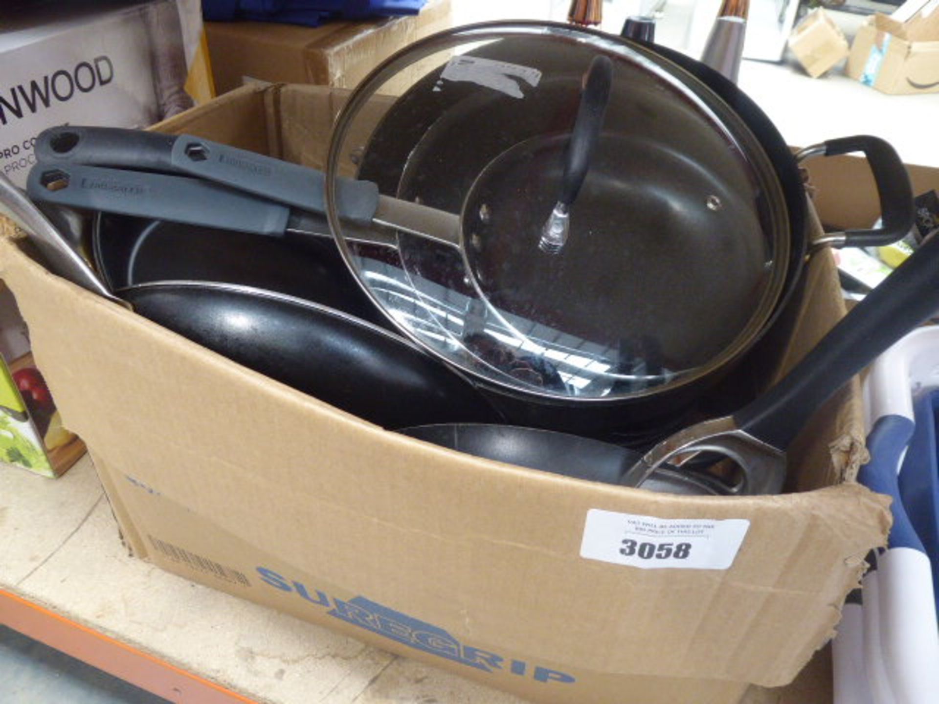 Box containing mixed used pots and pans