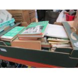 A box containing cricketing and football related reference books