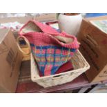 A wicker basket and a bag containing loose cutlery