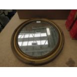 An oval mirror with gilt frame