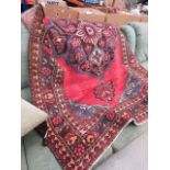 Floral mat with red background and central medallion