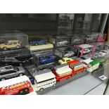 Shelf of unboxed buses with boxed diecast cars