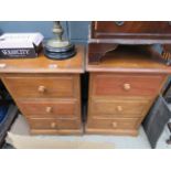 A pair of pine three drawer bedside cabinets