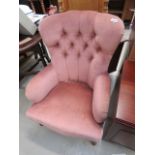 A pink fabric button back armchair