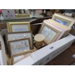Box containing various framed prints